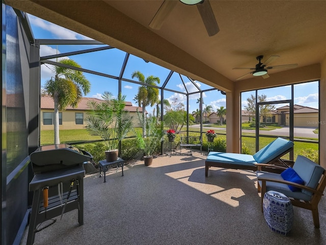 sunroom / solarium featuring ceiling fan