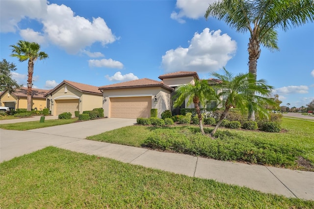 mediterranean / spanish-style home with a front yard and a garage