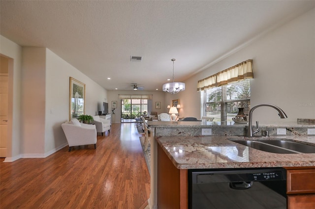 kitchen featuring light stone countertops, a textured ceiling, sink, black dishwasher, and dark hardwood / wood-style floors