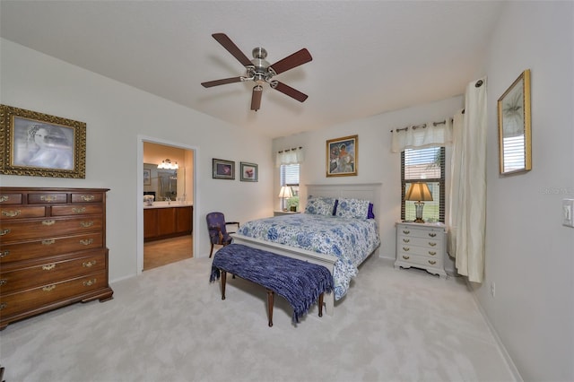 carpeted bedroom with ceiling fan and connected bathroom