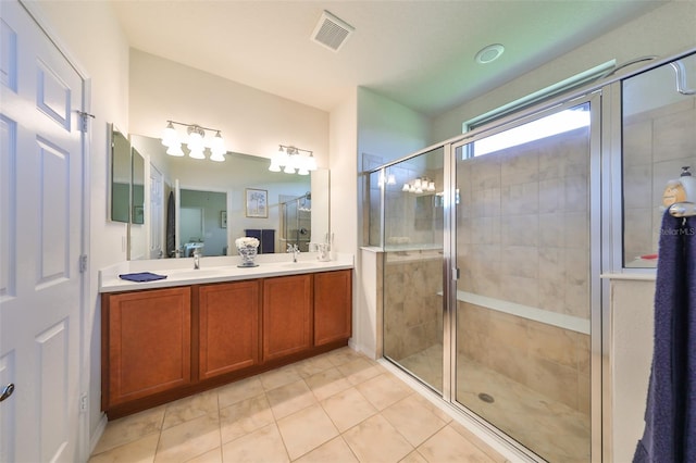 bathroom featuring tile patterned floors, vanity, and an enclosed shower