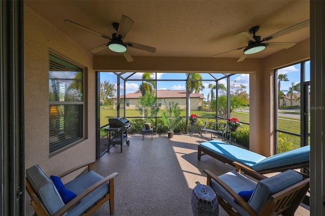 sunroom featuring ceiling fan