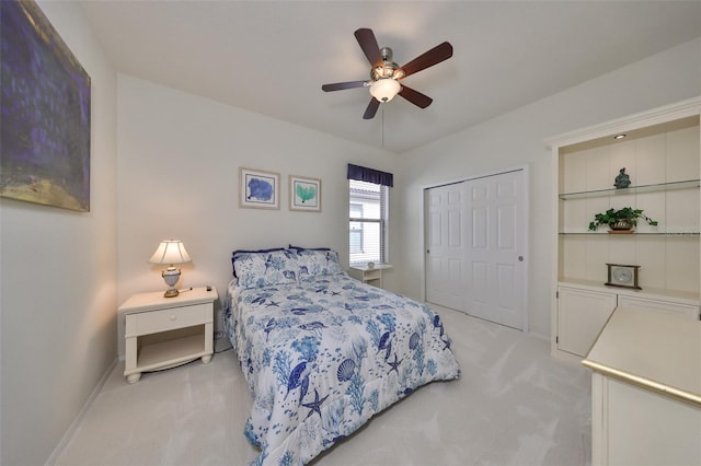 carpeted bedroom with ceiling fan and a closet