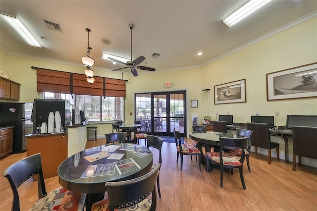 dining space with ceiling fan, light hardwood / wood-style flooring, and ornamental molding