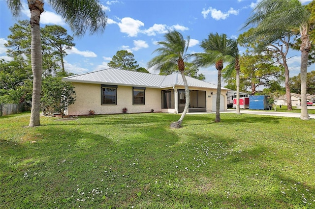 ranch-style home featuring a garage and a front lawn