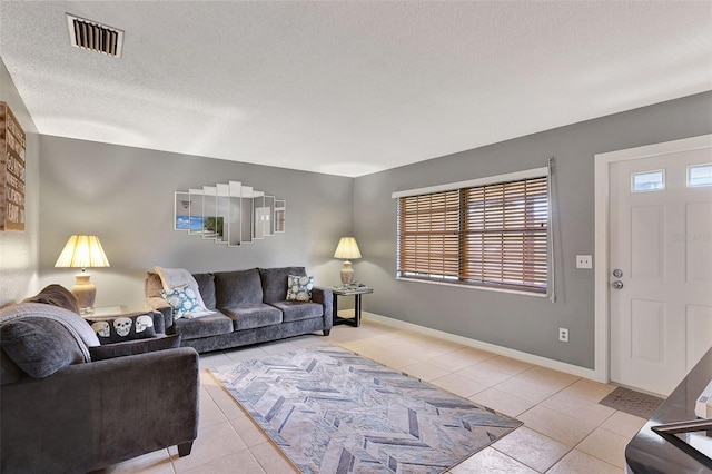 living room with light tile patterned floors and a textured ceiling