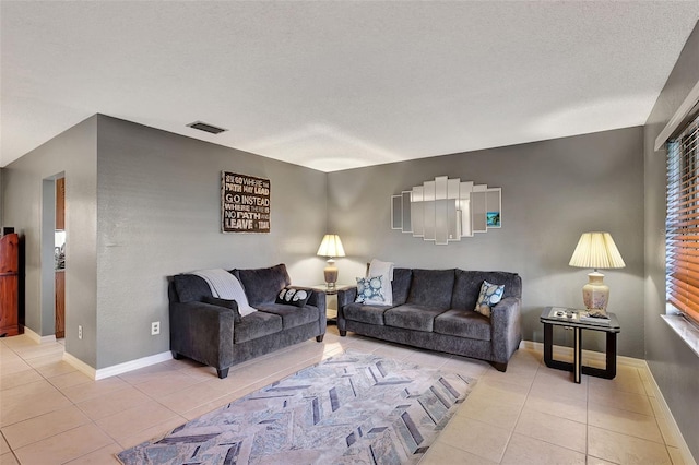 tiled living room with a textured ceiling