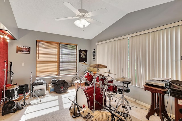 rec room featuring ceiling fan, light tile patterned floors, and lofted ceiling