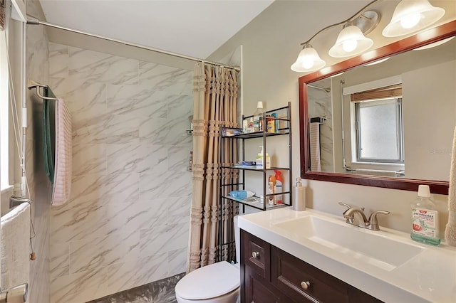 bathroom featuring walk in shower, vanity, and toilet