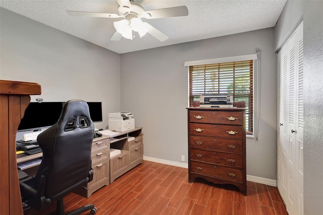 home office with ceiling fan, a textured ceiling, and light wood-type flooring