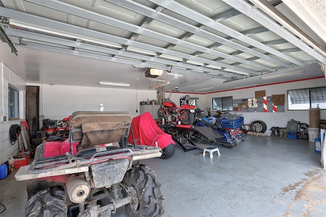 garage with a garage door opener and white refrigerator