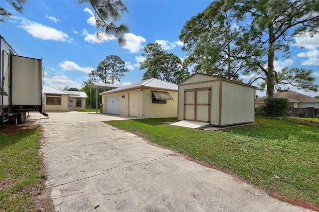 exterior space with a front lawn, a garage, and a storage shed