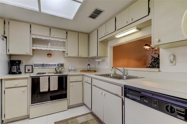 kitchen with white appliances, sink, a skylight, light tile patterned floors, and a chandelier