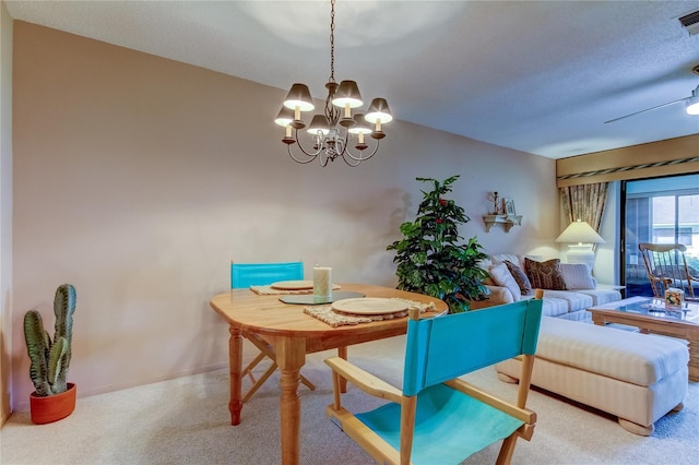 dining area featuring carpet and a notable chandelier