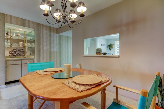 carpeted dining space with a chandelier