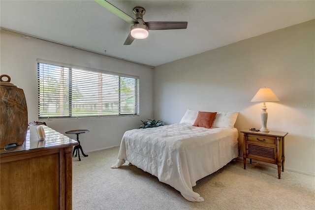 bedroom featuring ceiling fan and light carpet