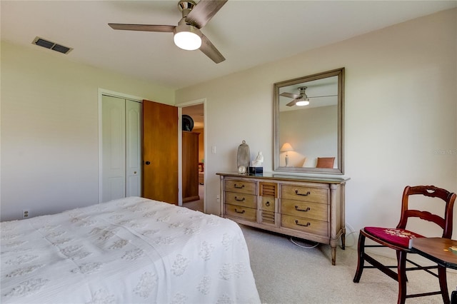 carpeted bedroom with a closet and ceiling fan