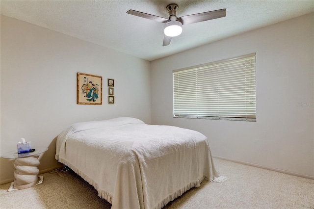 bedroom featuring carpet, ceiling fan, and a textured ceiling