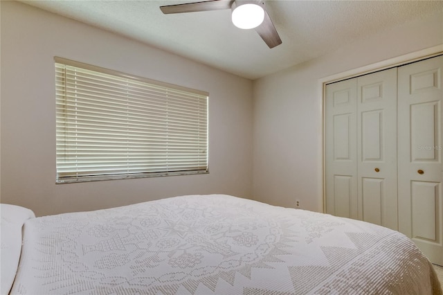 bedroom featuring a textured ceiling, a closet, and ceiling fan