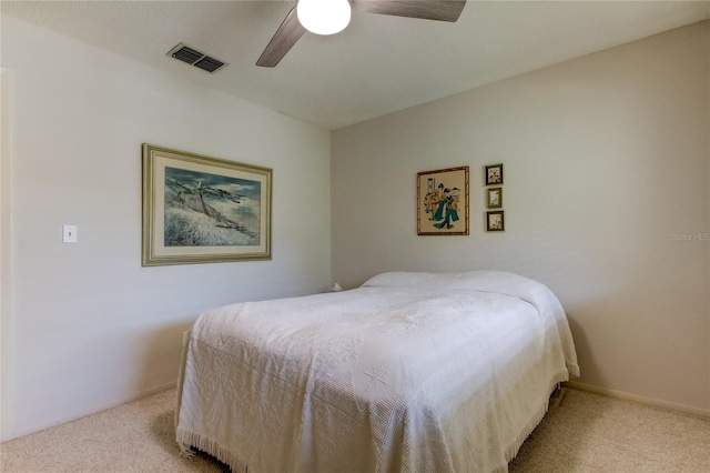 bedroom with ceiling fan and light carpet