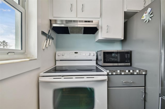 kitchen with white cabinets, stainless steel appliances, and range hood