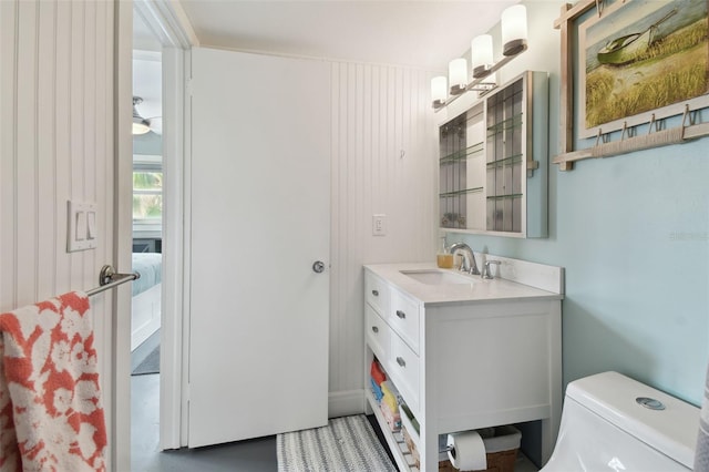 bathroom featuring concrete flooring, vanity, toilet, and ceiling fan