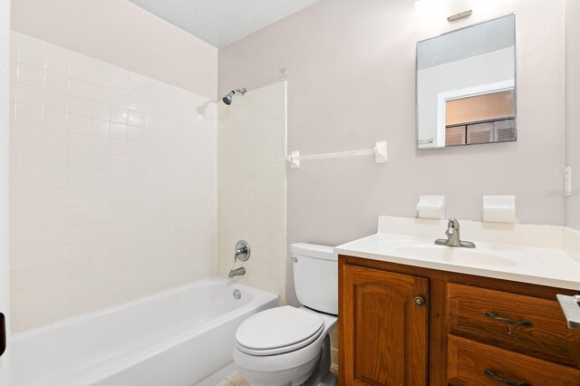 bathroom featuring shower / washtub combination, toilet, and vanity