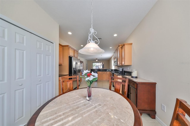 kitchen with kitchen peninsula, stainless steel appliances, and hanging light fixtures