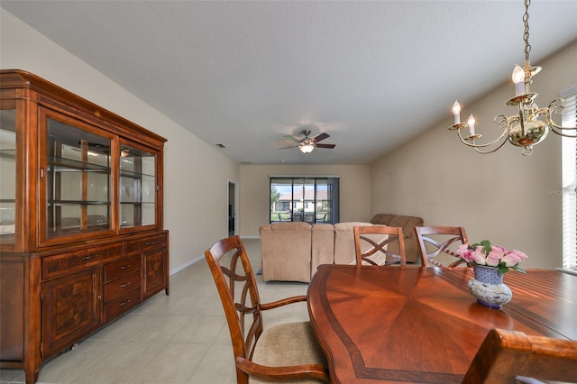 tiled dining room featuring a textured ceiling and ceiling fan with notable chandelier