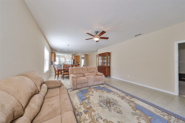 tiled living room with ceiling fan