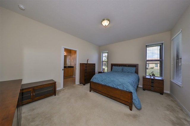 carpeted bedroom featuring connected bathroom