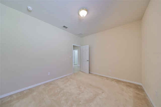 empty room with light colored carpet