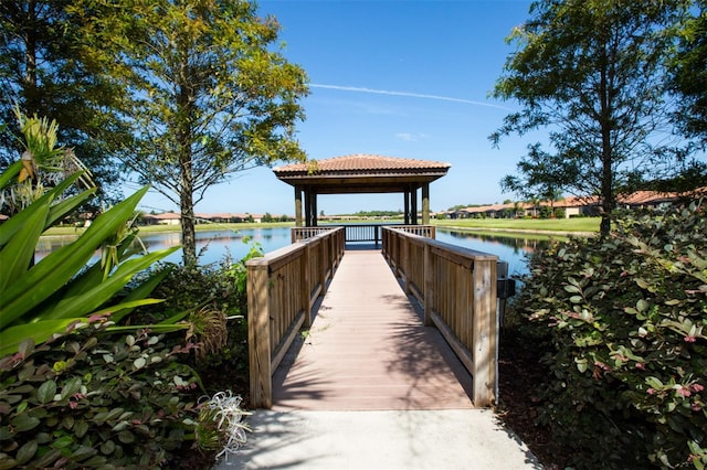 view of dock featuring a gazebo and a water view