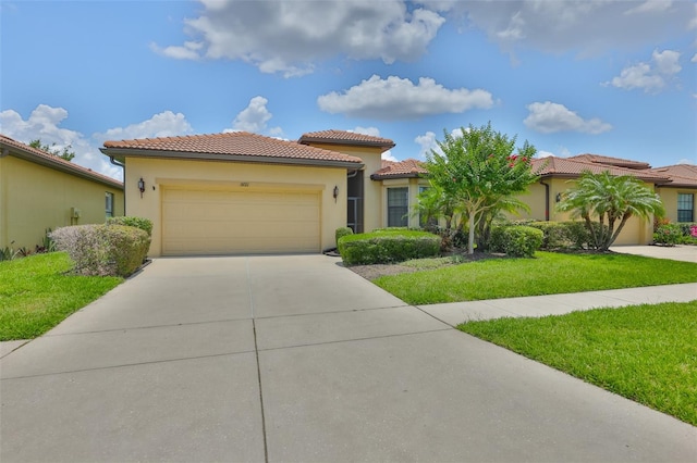 5721 Sunset Falls Dr, Apollo Beach, FL 33572 - mediterranean / spanish-style house with a garage, concrete driveway, a tiled roof, and a front lawn
