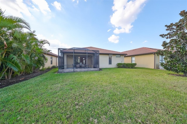 5721 Sunset Falls Dr, Apollo Beach, FL 33572 - rear view of house featuring a yard, stucco siding, a tile roof, and glass enclosure