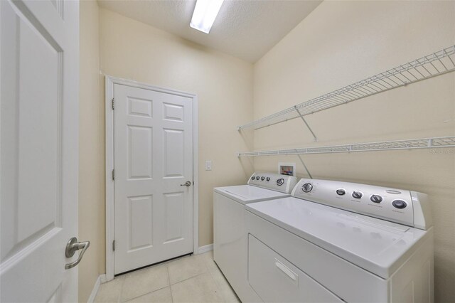 5721 Sunset Falls Dr, Apollo Beach, FL 33572 - laundry room with washer and dryer, baseboards, and light tile patterned flooring