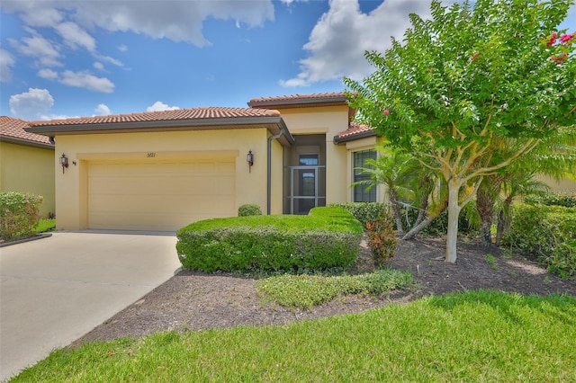5721 Sunset Falls Dr, Apollo Beach, FL 33572 - mediterranean / spanish-style home with a garage, stucco siding, concrete driveway, and a tiled roof