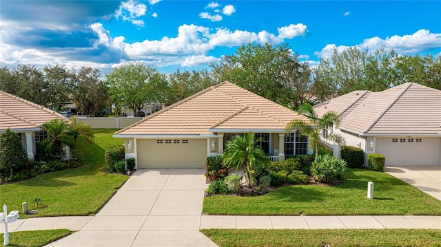 view of front of property featuring a front yard and a garage