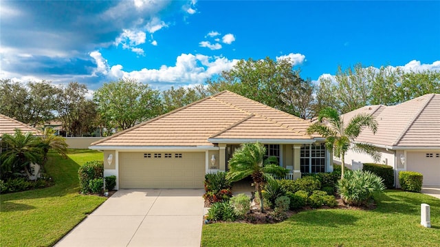 ranch-style house featuring a front yard and a garage