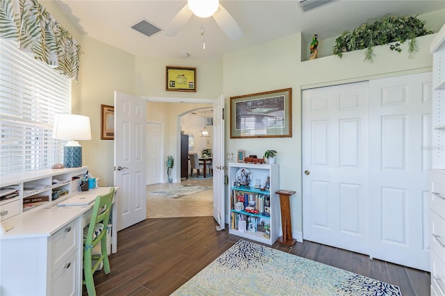 interior space with dark hardwood / wood-style flooring and ceiling fan