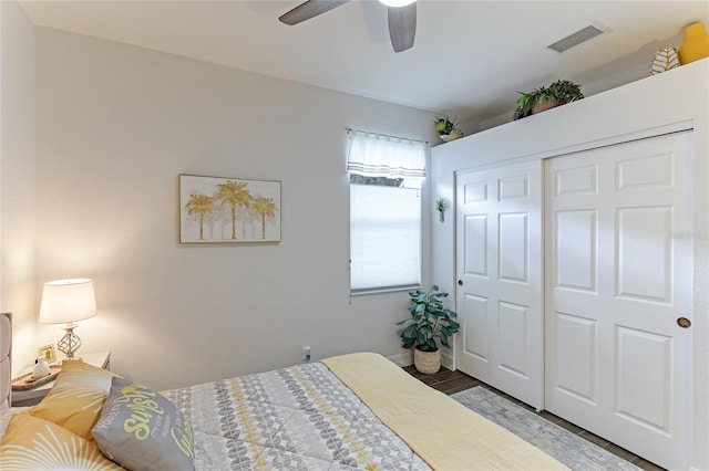 bedroom featuring hardwood / wood-style floors, a closet, and ceiling fan