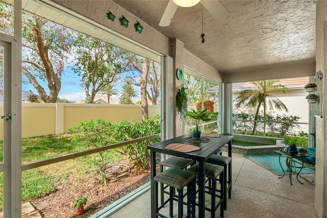 sunroom with ceiling fan