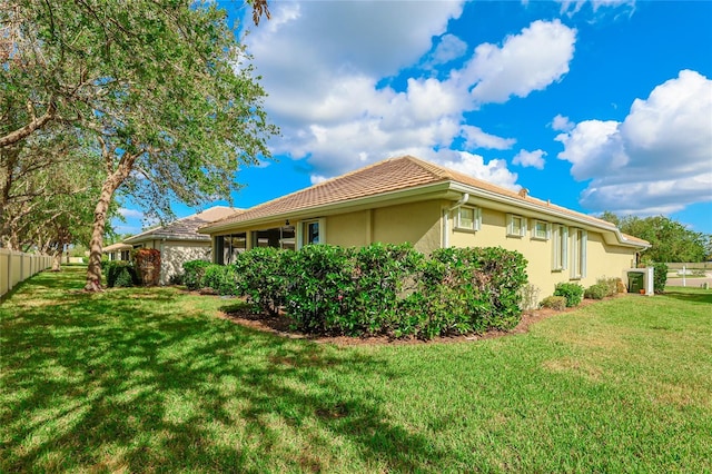 view of side of property with a lawn