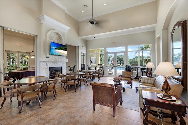 tiled living room with french doors, a healthy amount of sunlight, and a high ceiling