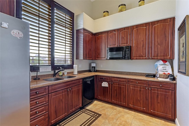 kitchen with light tile patterned flooring, sink, and black appliances