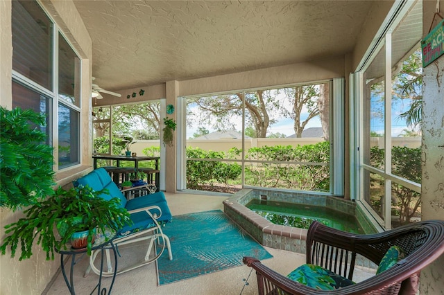 sunroom / solarium featuring a hot tub and ceiling fan