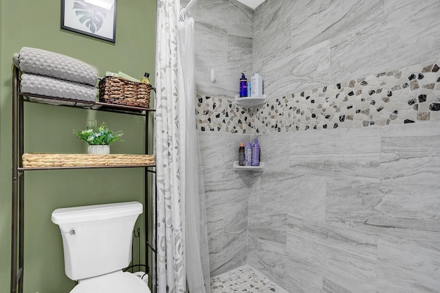 bathroom featuring toilet and walk in shower