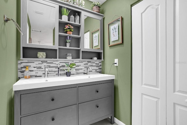 bathroom featuring vanity and tasteful backsplash