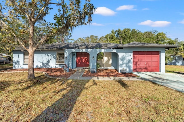 ranch-style house with a garage and a front lawn