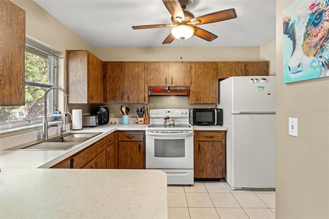 kitchen with light tile patterned floors, white appliances, ceiling fan, and sink